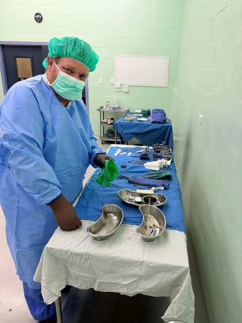 Pediatric surgical team around the operating table during a procedure.